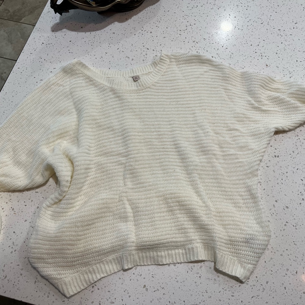 Mid length crop sweater in white with button design down back